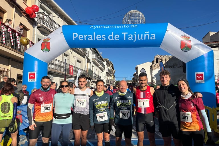 a group of people standing in front of a blue arch