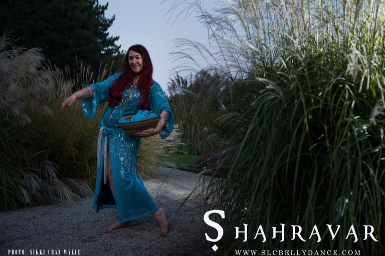 Bellydance Shahravar in Turquoise Assuit caftan dancing with basket