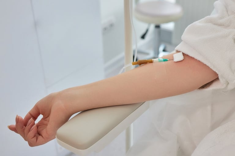 Patient receiving IV drip therapy treatment in a bright, modern medical clinic setting.