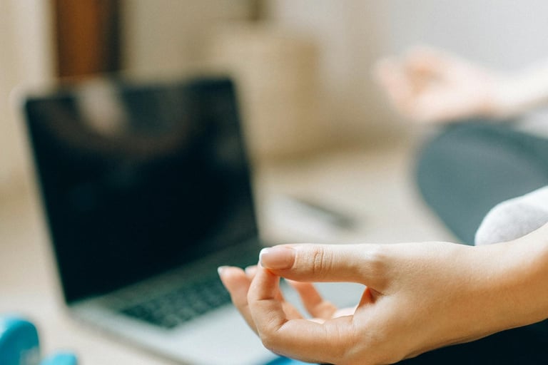 woman meditating with computer