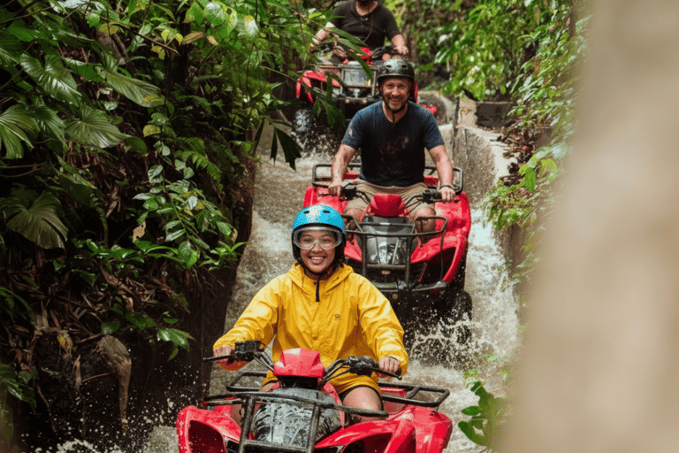 a group of people riding on four - wheelers through a river