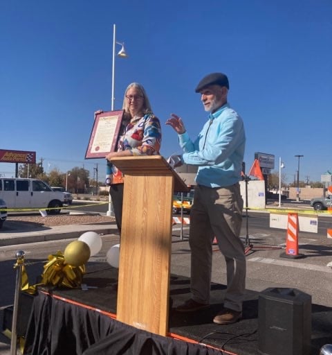 President of DCCNM holding Audrey Nelson Award at grand opening