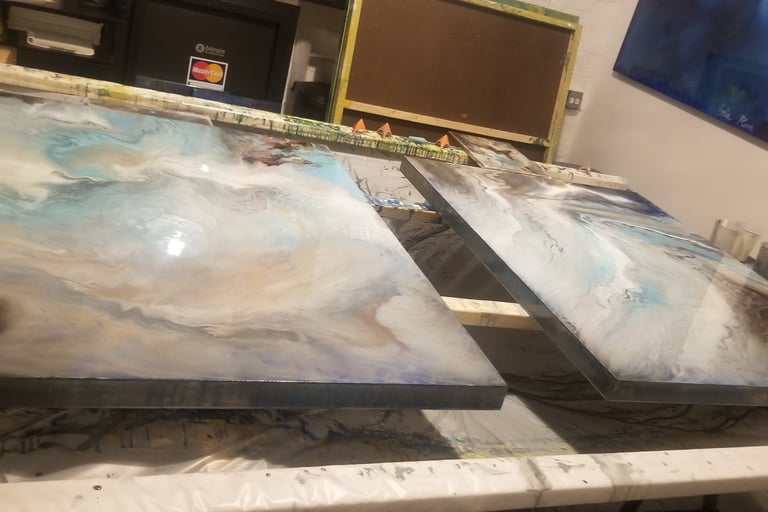 two large paintings of a painting of a wave