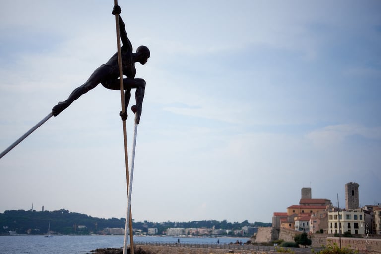 Sculptur of a man is doing a pole