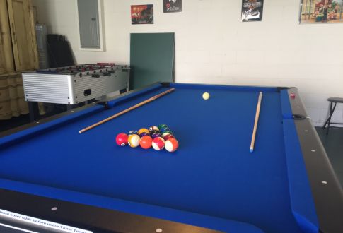 a pool table with a pool ball and a foosball table