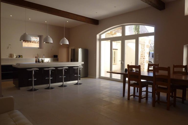 Open-plan kitchen and dining area renovated with modern finishes and natural light