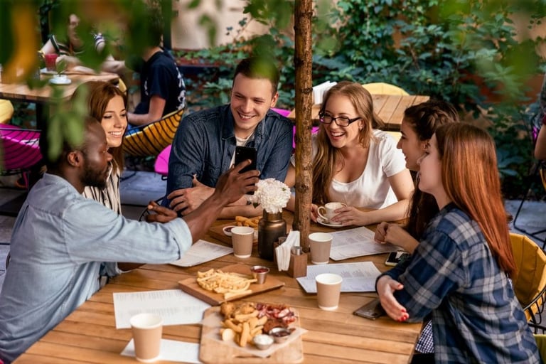 a group of friends sitting around a table
