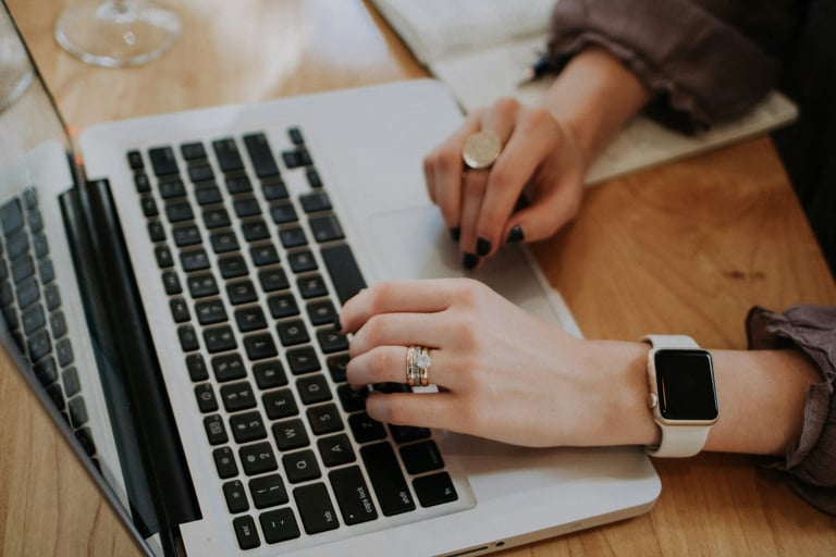 a woman's hands on a laptop computer