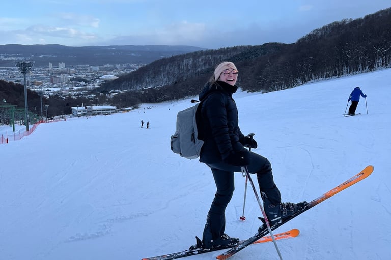 a girl laughing and skiing in sapporo hokkaido japan