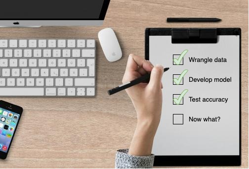 a person holding a pen and writing on a clipboard