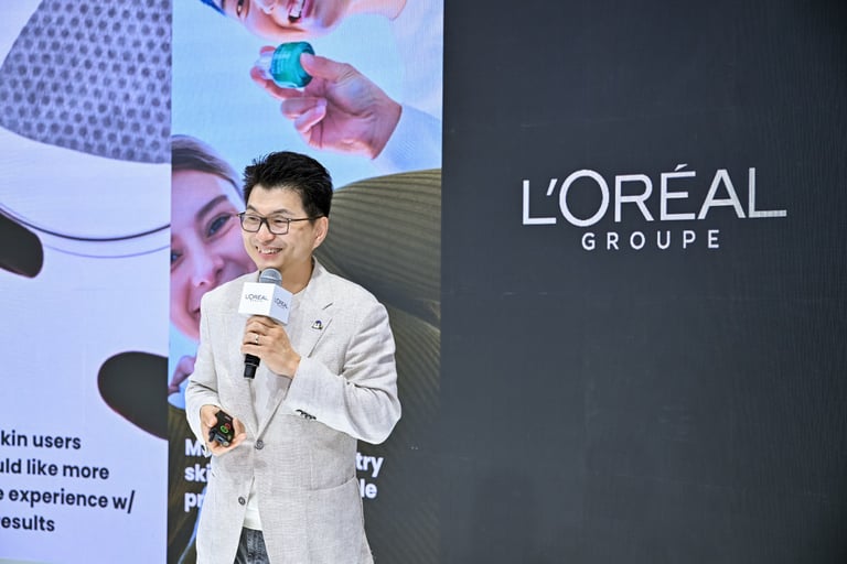A L'Oréal speaker presenting corporate beauty technology at a business conference.
