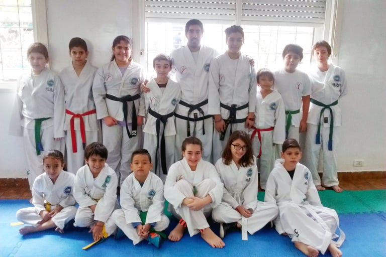 a group of kids and adults in karate gear