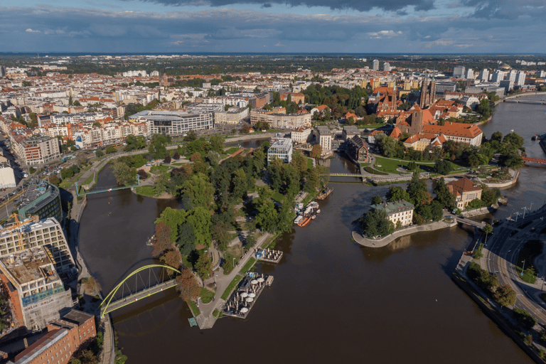 Aerial view of Wroclaw, Poland, featuring the Oder River, historic bridges, and lush green city islands.
