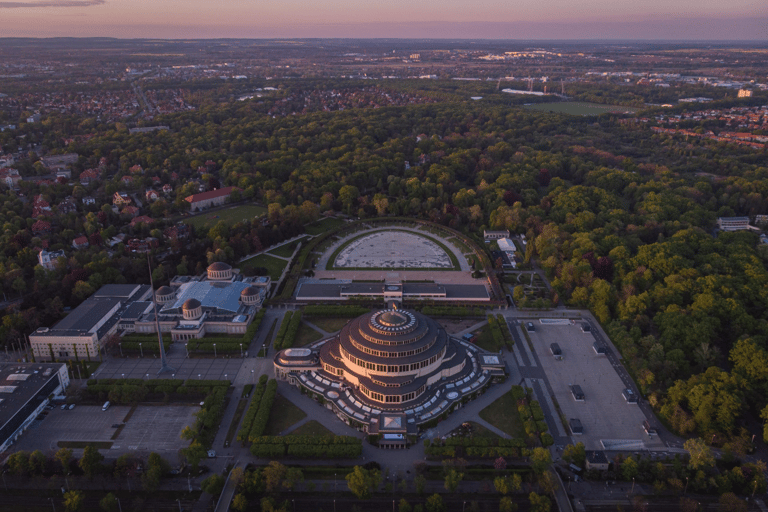 Aerial view of Centennial Hall and the surrounding park in Wroclaw, Poland at sunset.