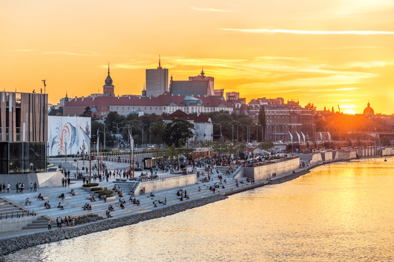 Golden sunset over the Vistula river boulevards and Old Town skyline in Warsaw, Poland.