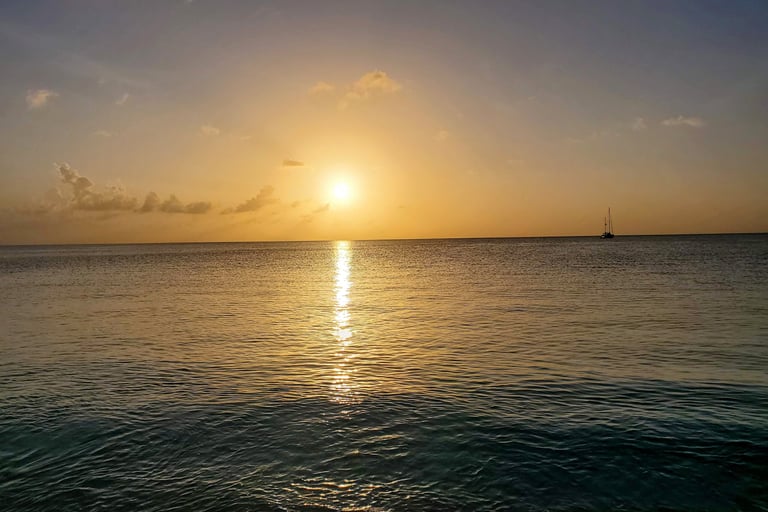 Jolly Beach Antigua – golden sunset over calm Caribbean water on Antigua's west coast