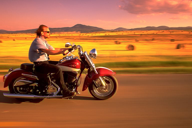 a man riding a motorcycle on a road