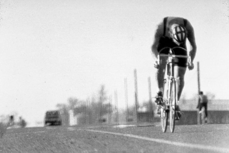 a man riding a bicycle on a road
