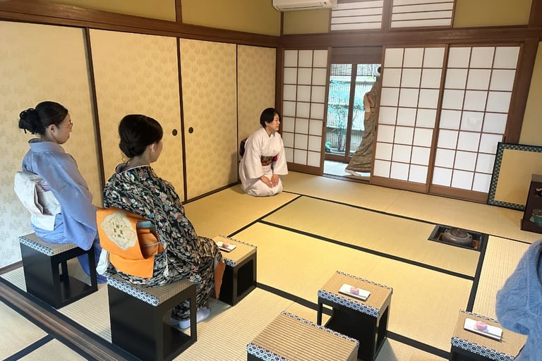 Woman in a kimono seated in a traditional Japanese tea room