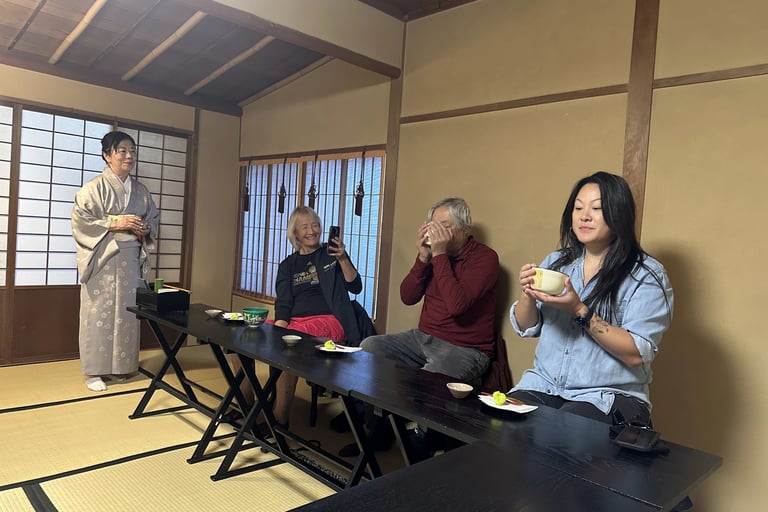 Family enjoying a traditional Japanese tea ceremony together in a tatami room.