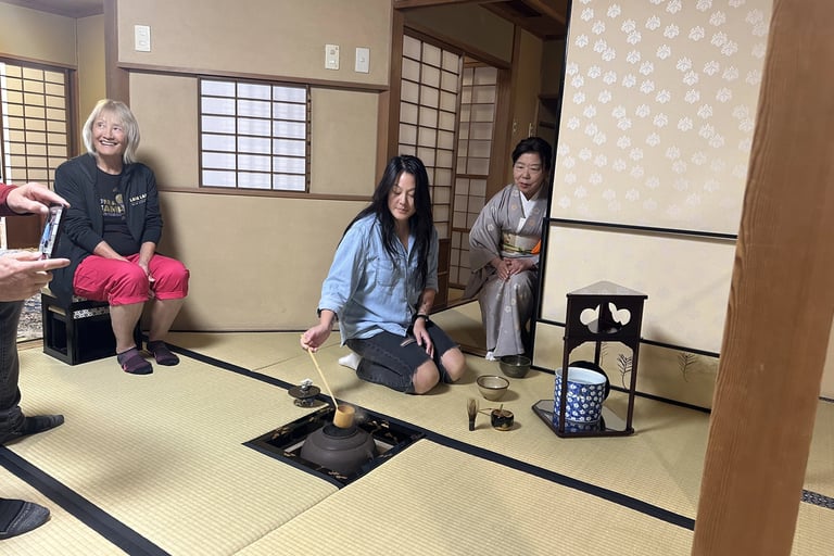 A young woman in a traditional tea ceremony, preparing matcha in a calm tatami room.