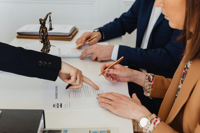 Couple signing divorce papers in a lawyers office dissolving their marriage