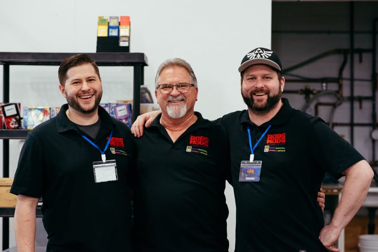 Rob's Mods team standing proudly together at their booth as sponsors of the event.