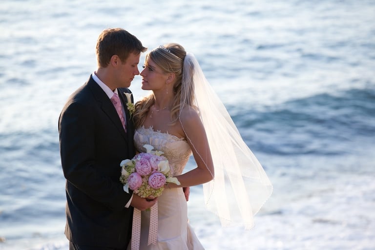 Bride holding pink and white wedidng bouquet with groom at cuvier park, la jolla