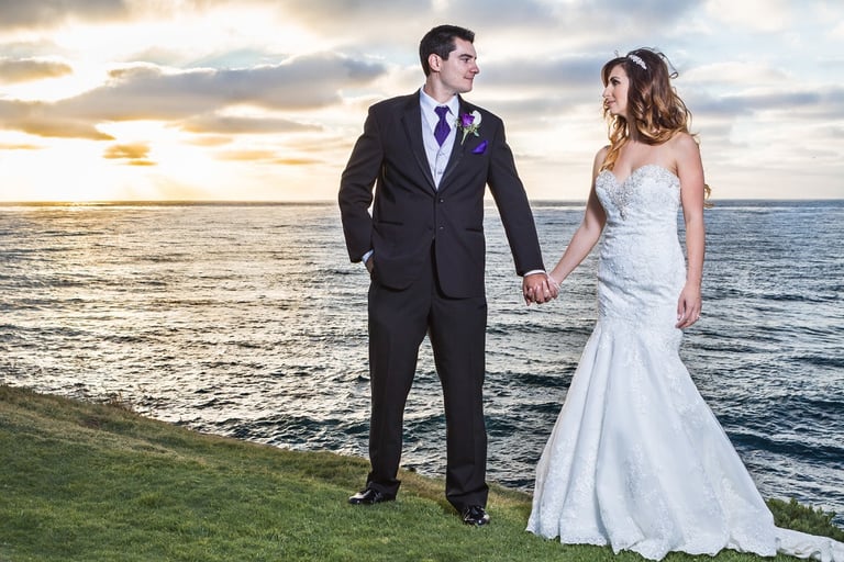 couple standing on the grass of Cuvier park in La jolla at sunset