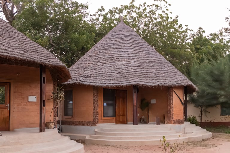 A scenic view of Tendaba Camp in Kwinella, situated along the peaceful riverbank and surrounded by l