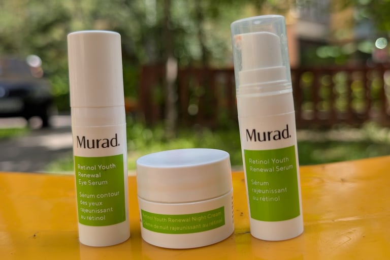 Murad Retinol Youth Renewal skincare set including eye serum, night cream, and face serum on a yellow surface.