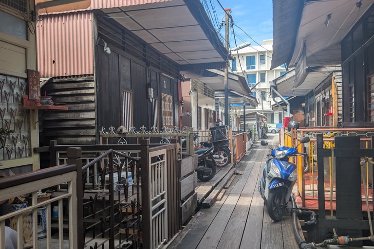 Traditional wooden houses along a narrow boardwalk at new/mixed Jetties in George Town, Penang.