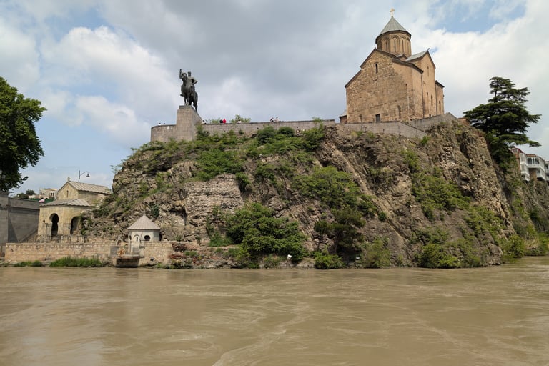 view of Metekhi Church of the Nativity of the mother of god across the Rura river in Tbilis georgia