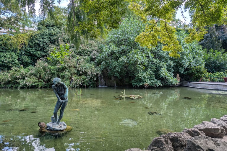 A statue of a boy in a Japanese pond on Margaret Island, Budapest, Hungary