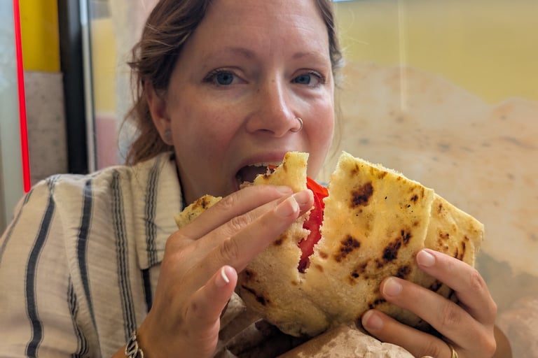 Samantha eatting a Pljeskavica a national dish of Serbia in Novi Sad, Serbia