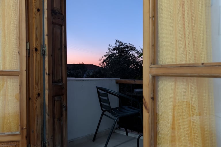 sunset view from the balcony of Karya apartment in Petra Greece