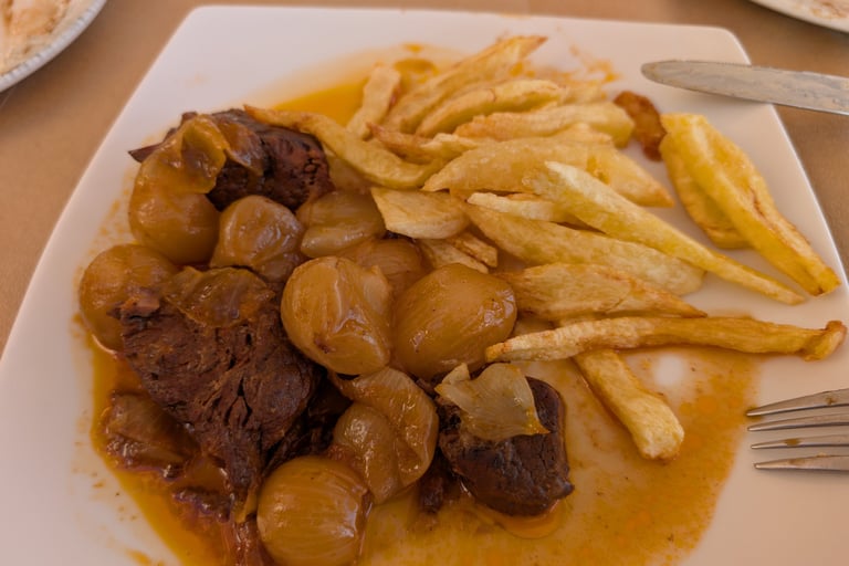 veal stafado with French frys at The Octopus Restaurant in Mithymna Greece