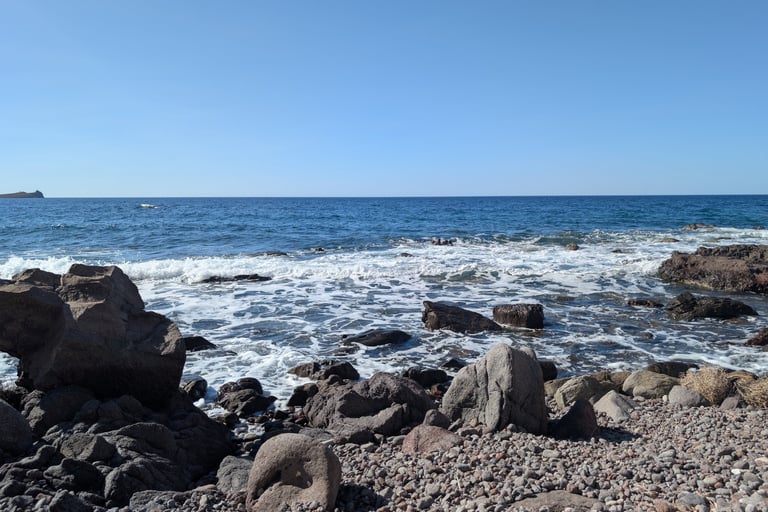 Waves crashing  on a rocky beach in Petra Greece