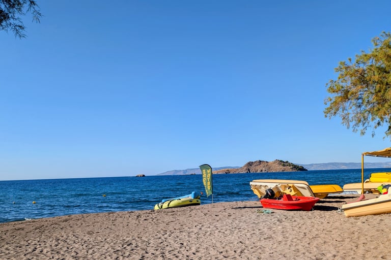 Sandy Beach on the Agaean  Sea with boats for rent on Parlia Anaxos Beach in Petra Greece