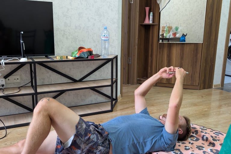 don laying on the floor in the livingroom  Apartment 16 in Tbilisi Georgia 