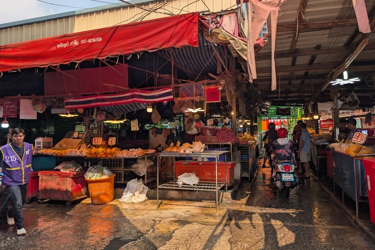 Kholong Toei market in Thailand with street food vendors, local meat, and motorbikes.