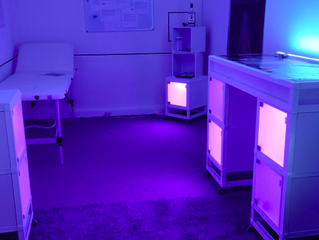 A modern escape-room with white medical furniture illuminated