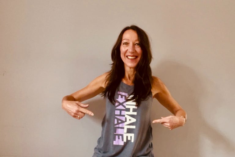 Lady wearing a T-shirt which says Inhale Exhale on it