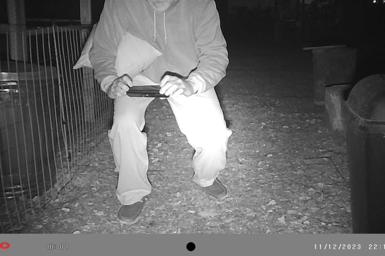 Martin taking a picture of the rat he shot.