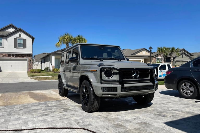Gray Mercedes G-Wagon freshly detailed on a paver driveway in carrollwood neighborhood