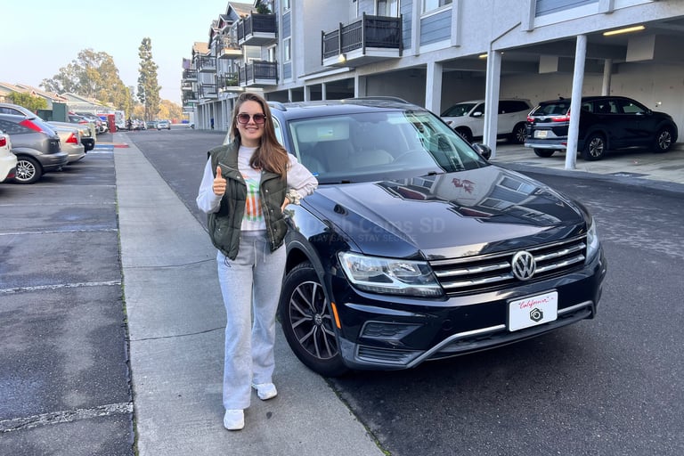Lady standing in front of Volkswagen Tiguan 2019