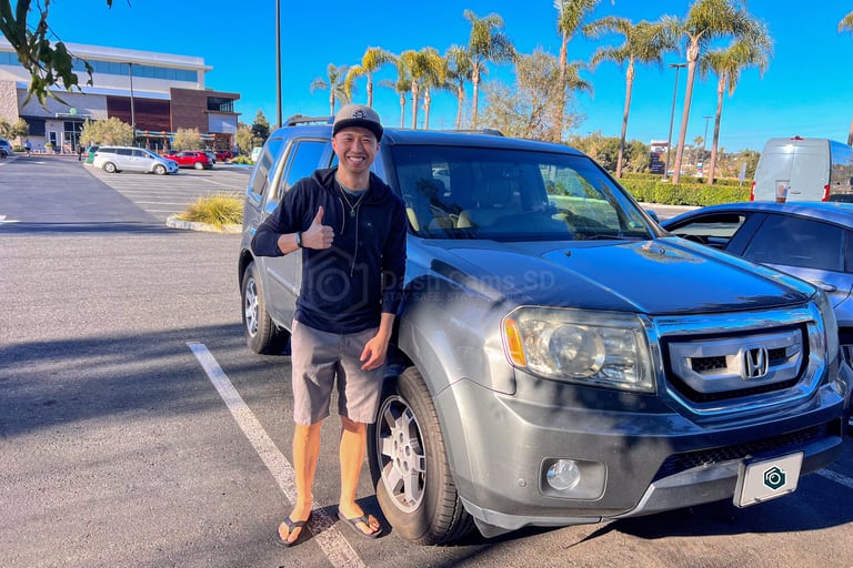 man standing in front of 2009 honda pilot