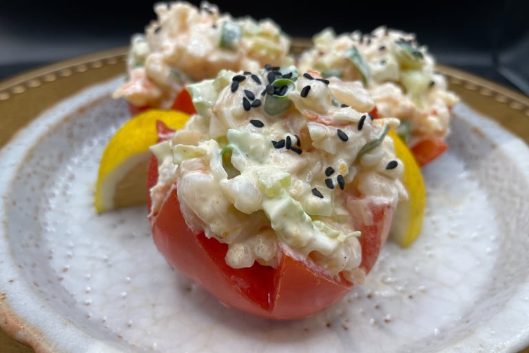 a plate with a crab salad on in stuffed tomato