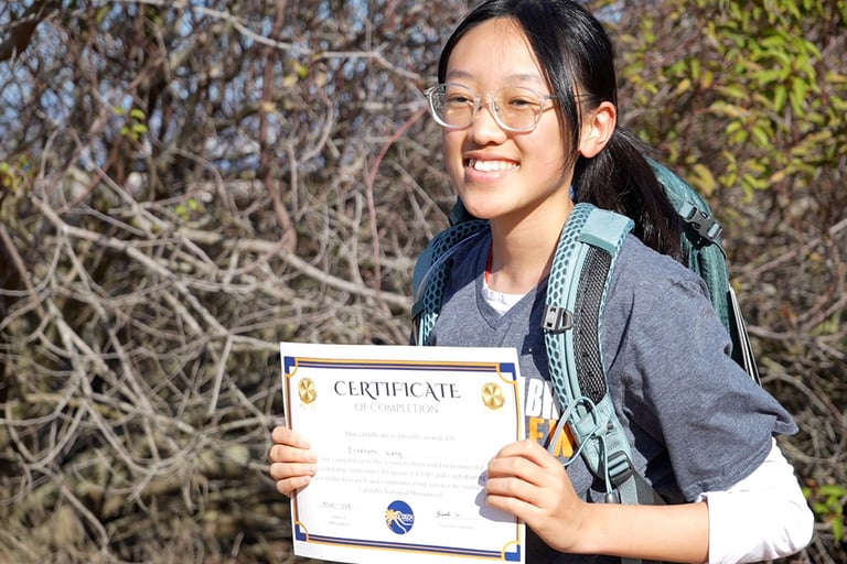 student holding a certificate