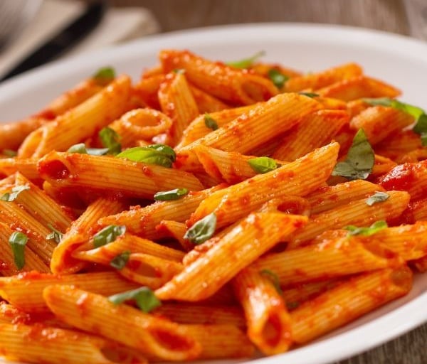 a plate of pasta with a red sauce